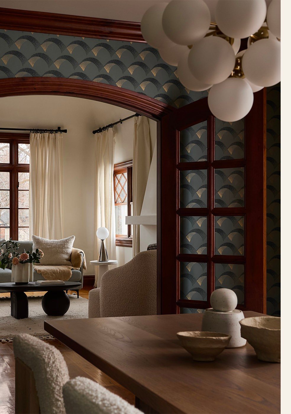 Dining room under a tiled arch with globe chandelier