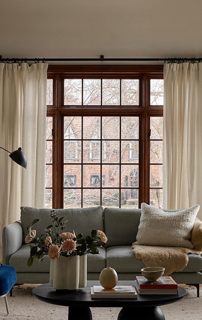 Living room with grey sofa and tall windows