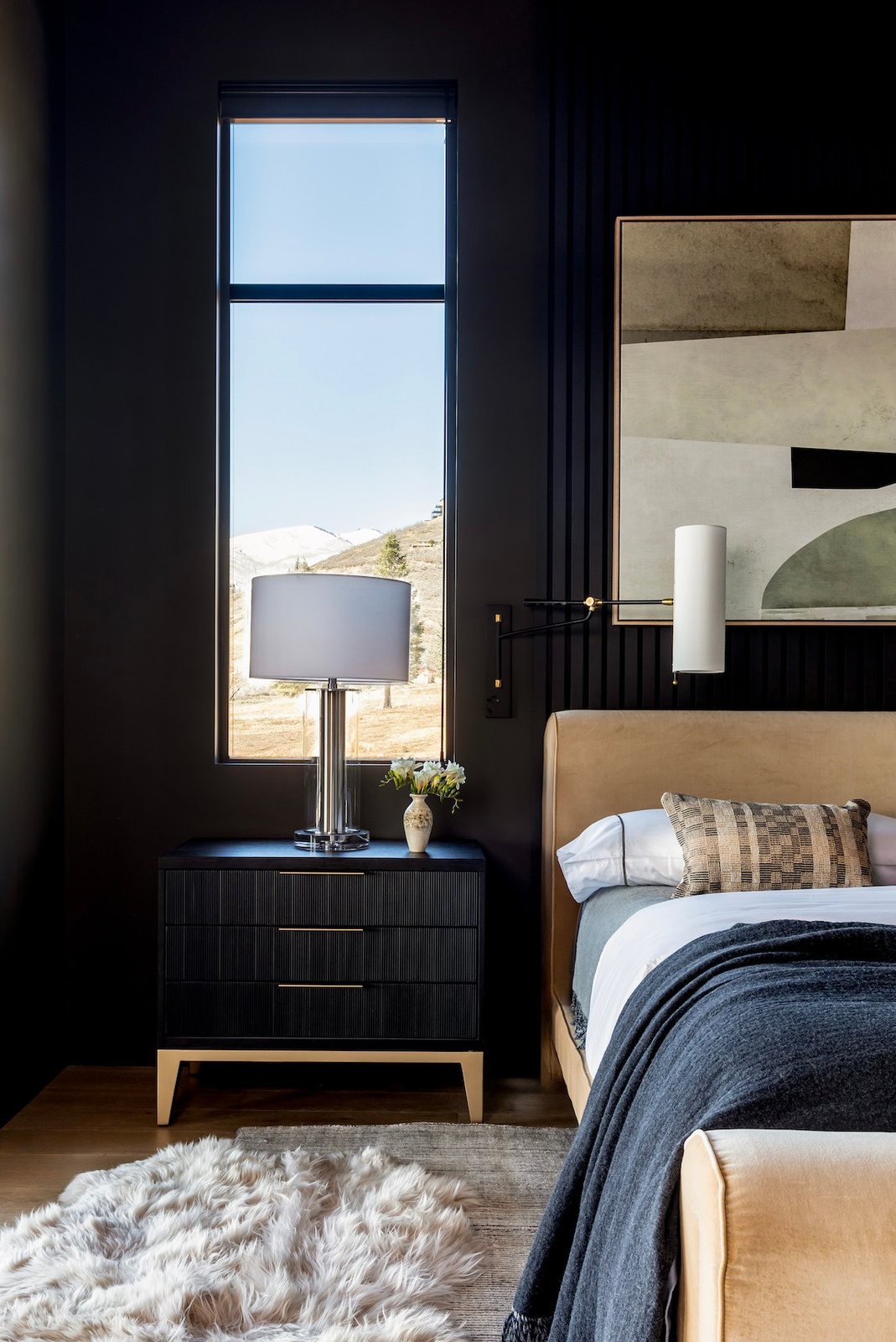 Moody bedroom with dark walls and upholstered bed
