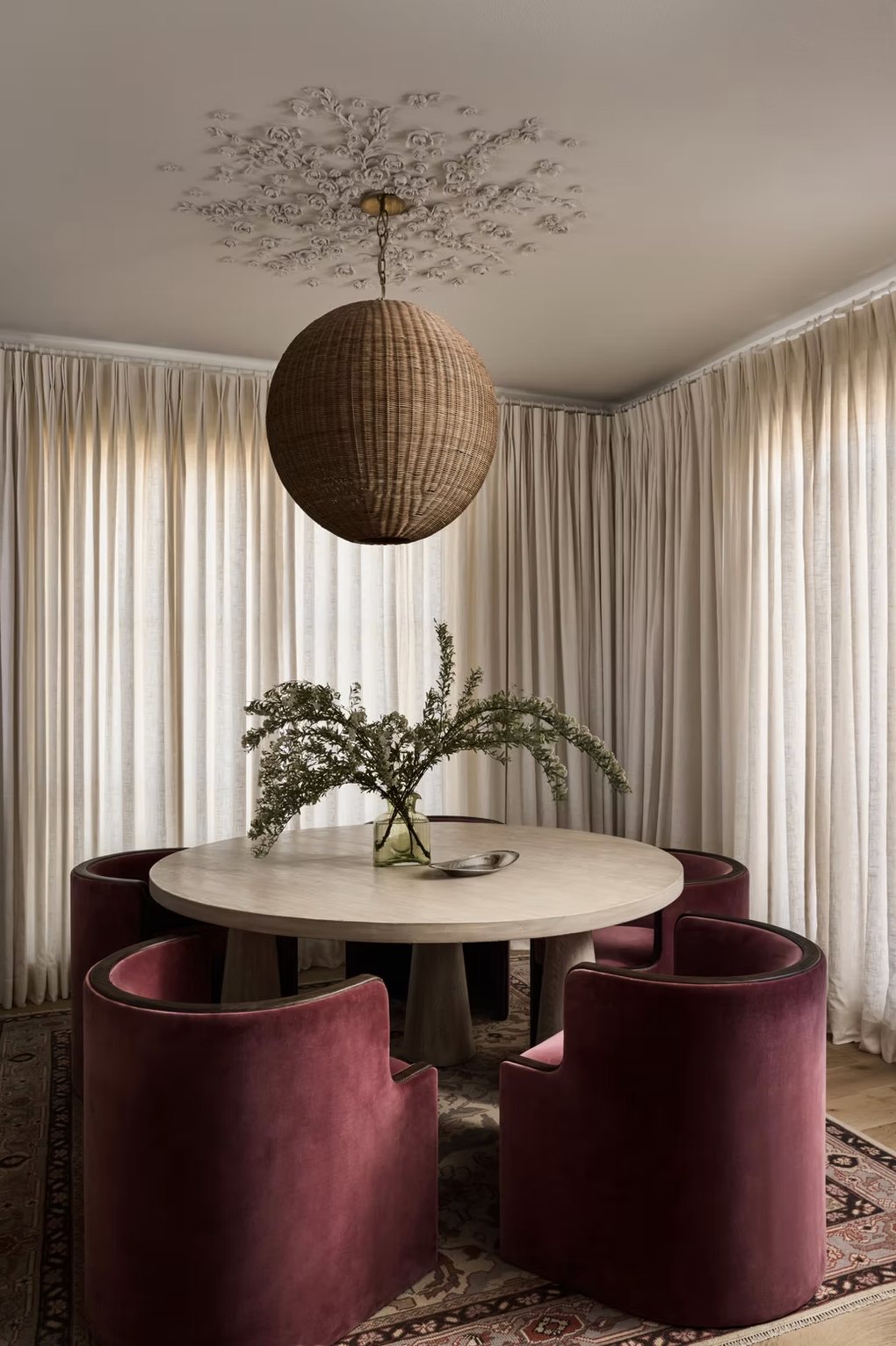 Eagle dining room with burgundy velvet chairs and woven pendant