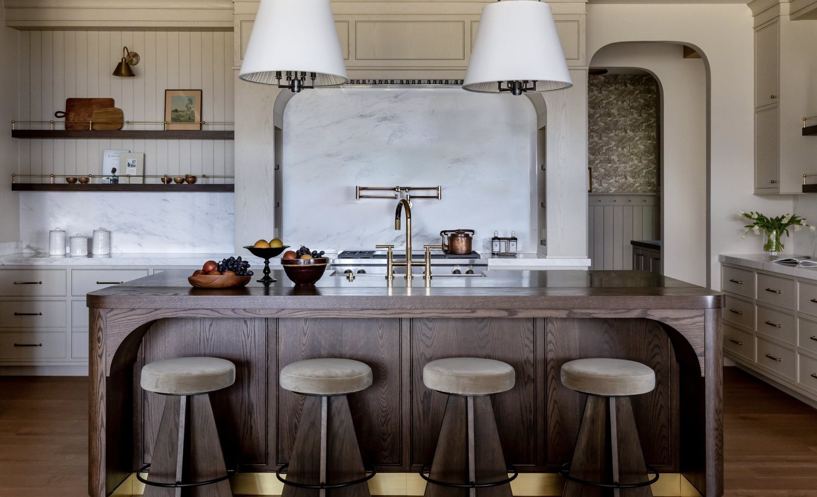 Mountainside kitchen with arched marble range alcove and oak island