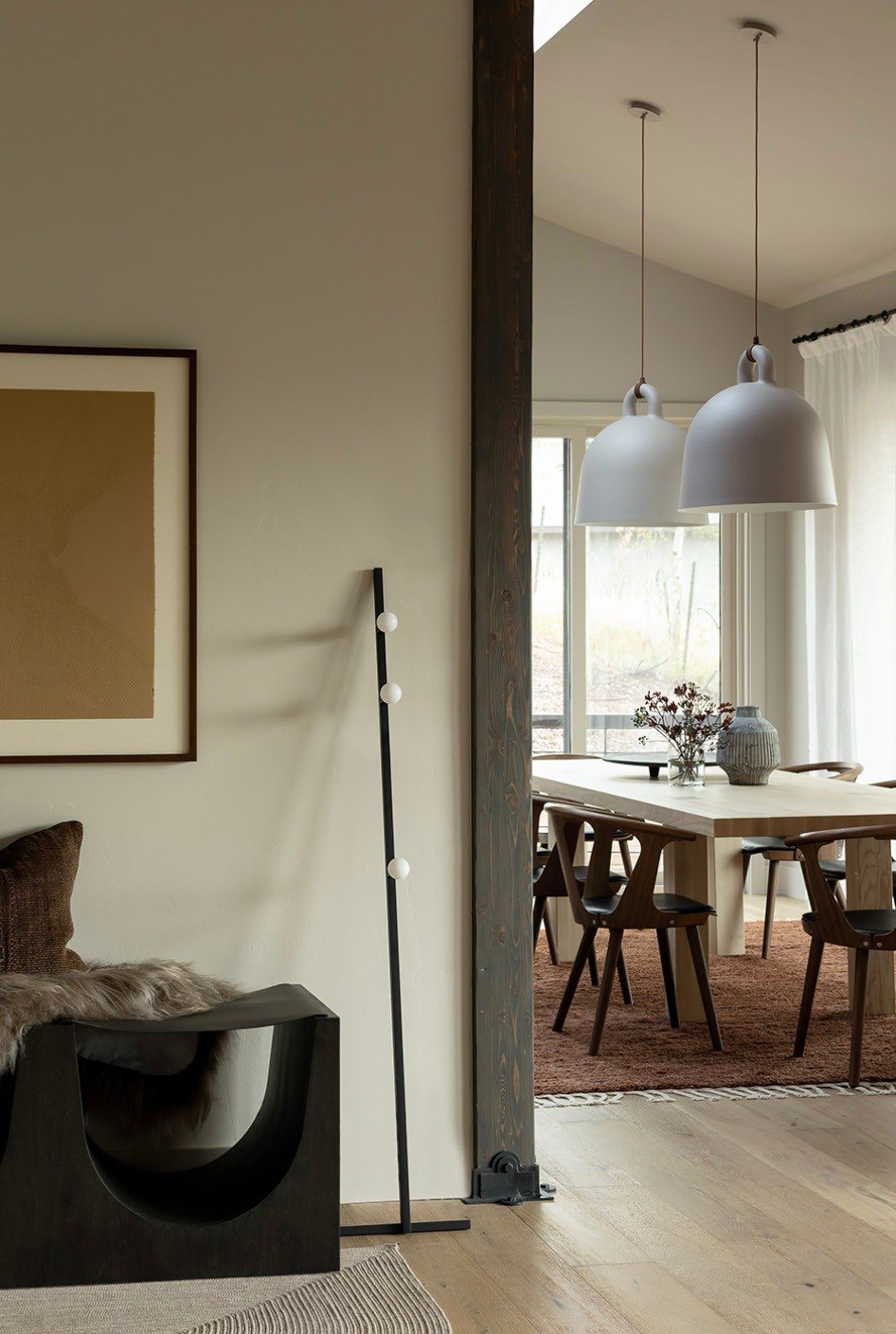 Living area opening to dining room with pendant lights